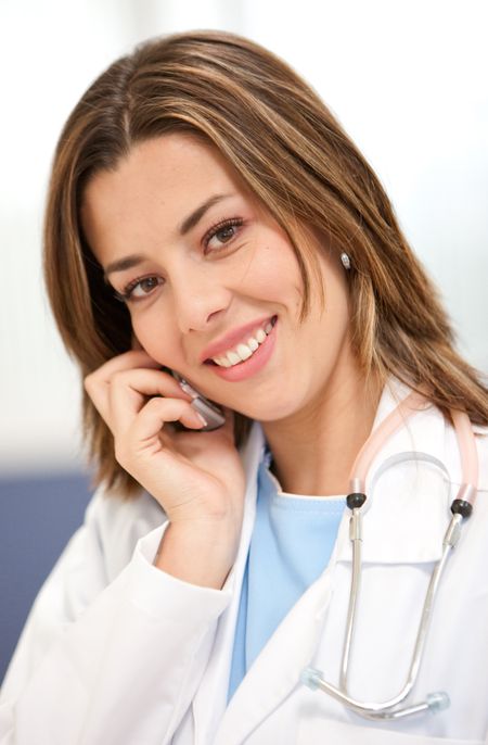 Female doctor talking on the phone at the hospital