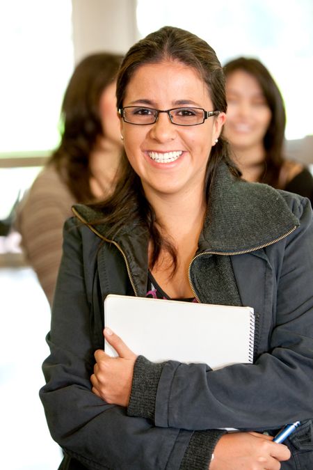 female university student in a classroom smiling