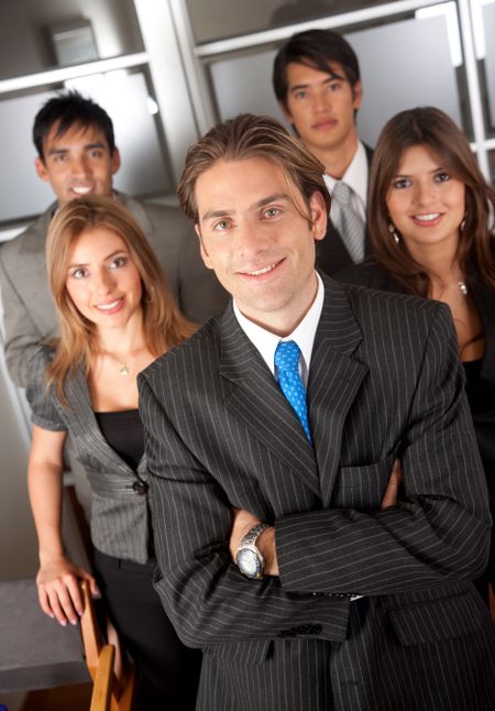 group of business people standing in an office smiling