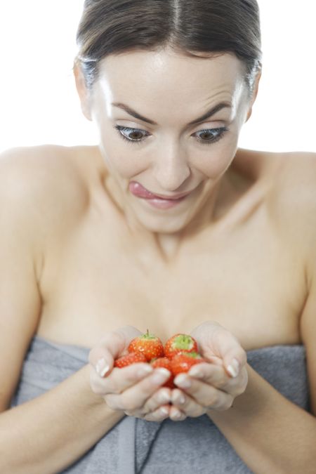 Attractive woman holding a bunch of strawberries