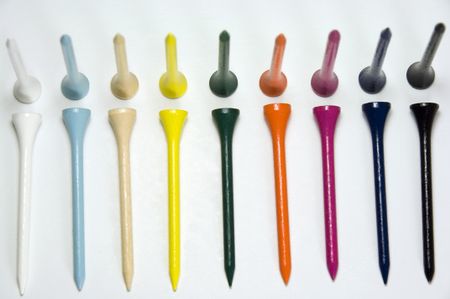 Golf tees of different colors aligned in two rows