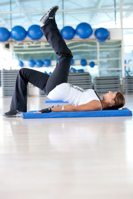 Woman at the gym doing stretching exercises