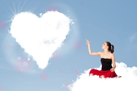 Beautiful young lovely woman sitting on cloud with heart