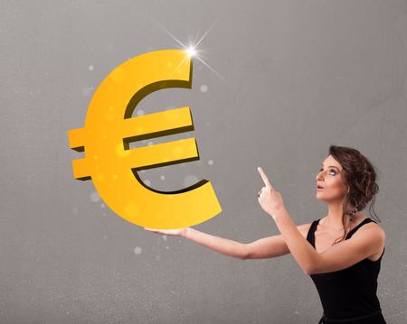 Beautiful young girl holding a big 3d gold euro sign