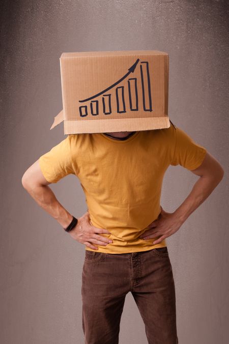 Young man standing and gesturing with a cardboard box on his head with diagram