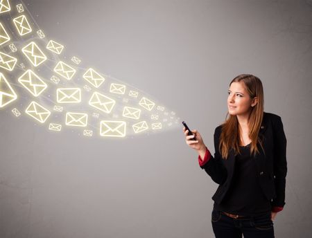 attractive young lady standing and holding a phone with message icons