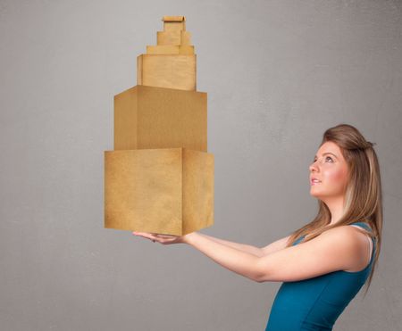 Attractive young lady holding a set of brown cardboard boxes