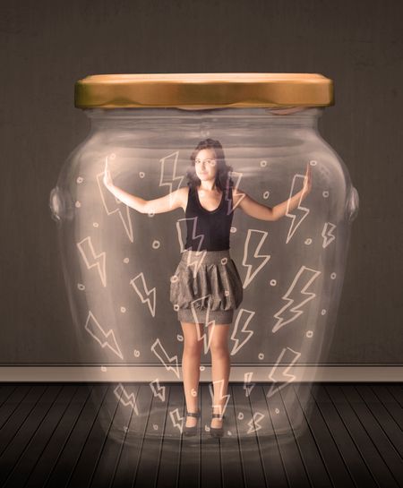 Businesswoman inside a glass jar with lightning drawings concept on background