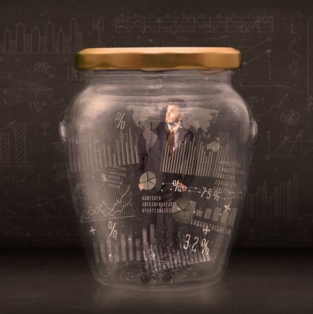 Businessman traped in jar with graph chart symbols concept on background