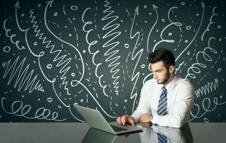 Businessman sitting at table with drawn curly lines and arrows on the background