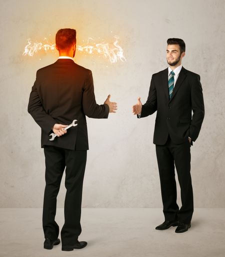 angry-businessman-hiding-weapon-back-245019394 Angry businessman hiding a weapon behind his back