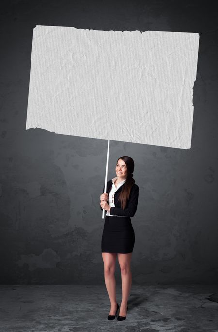 Young businesswoman holding a big blank booklet paper