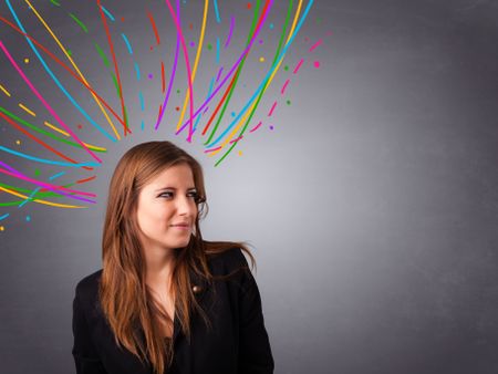 Pretty young girl thinking with colorful abstract lines overhead