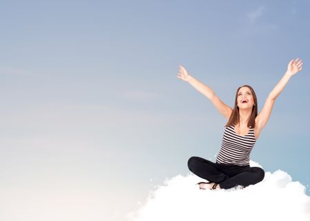 Beautiful young woman sitting on cloud with copy space