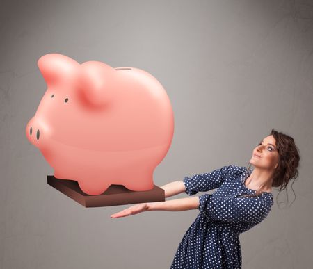 Beautiful young girl holding a huge savings piggy bank