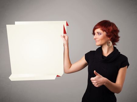 Baeutiful young woman holding white origami paper copy space