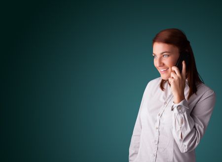 Young woman standing and making phone call with copy space