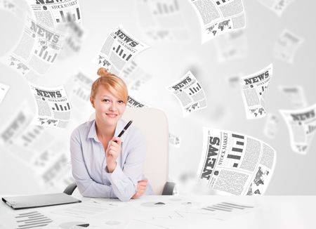 Business woman at desk with stock market newspapers concept