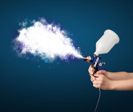 Painter with airbrush gun and white magical smoke concept