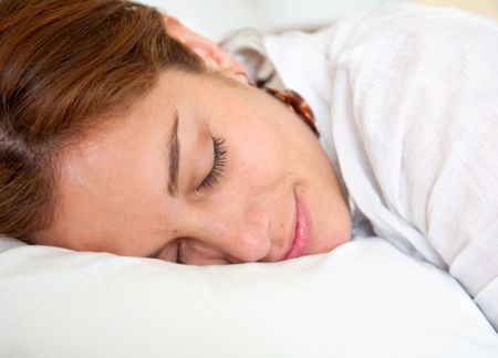 Beautiful woman sleeping over a white pillow
