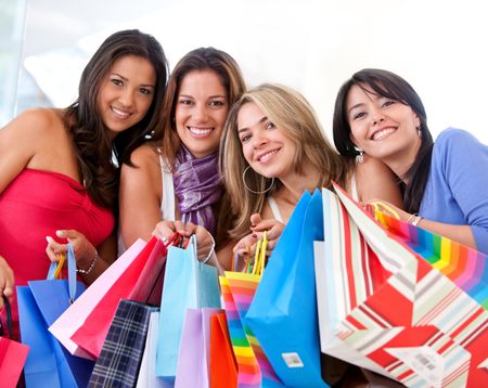 group of women shopping in a mall with some bags