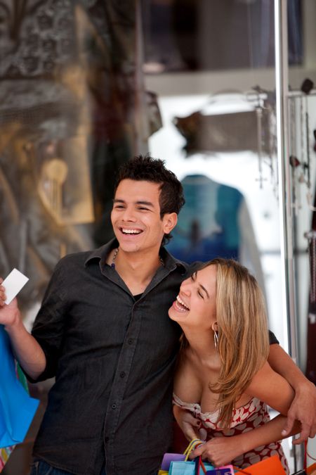 Happy couple of shoppers at a shopping mall