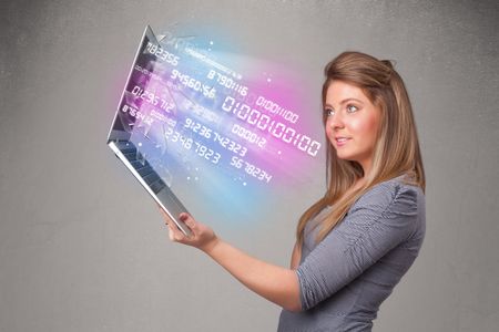 Attractive casual woman holding laptop with exploding data and numers