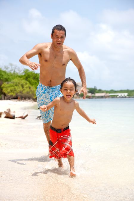 Man and son running on the beach