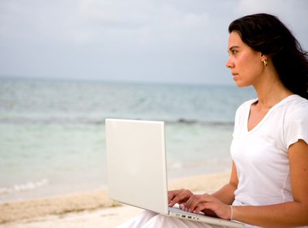 happy beach woman on a laptop during vacations