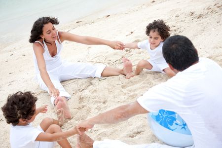 Family at the beach making a circle