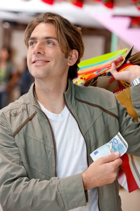 Shopper holding some bags and a note