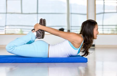 Woman stretching her torso at the gym