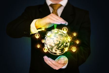 Businessman holding a shining globe with social media connection 