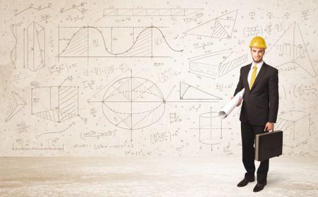 Handsome engineer calculating with hand drawn background concept