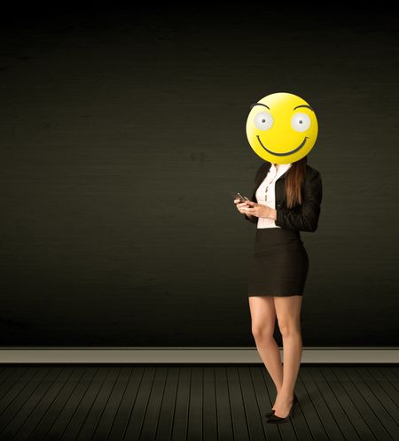 Funny businesswoman wears yellow smiley face