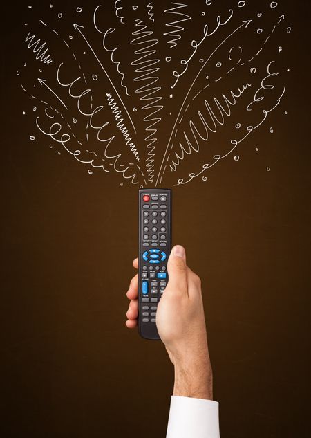 Hand holding a remote control, curly lines and arrows coming out of it 
