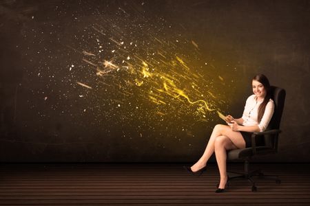 Businesswoman with tablet and energy explosion on background concept