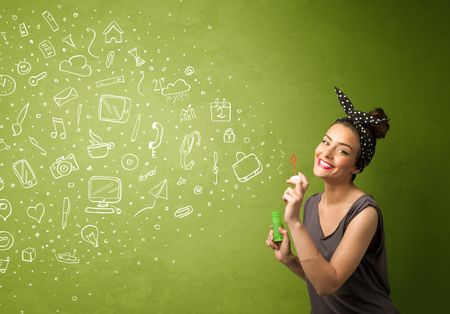 Cute girl blowing hand drawn media icons and symbols on green background