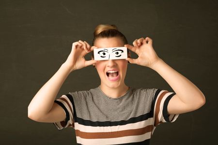 Silly youngster looking with hand drawn eye paper concept