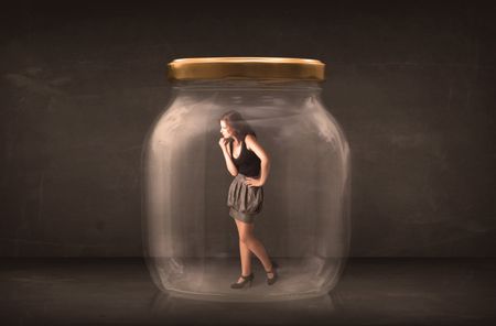 Businesswoman captured in a glass jar concept concept on background