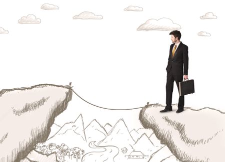 Businessman standing on the hand drawn edge of mountain