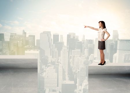 Businesswoman standing on the edge of rooftop with city background 