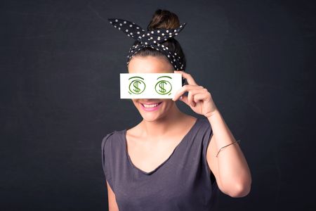 Young girl holding paper with green dollar sign concept