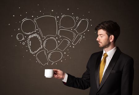 Businessman standing and holding a white cup with drawn speech bubbles coming out of the cup 