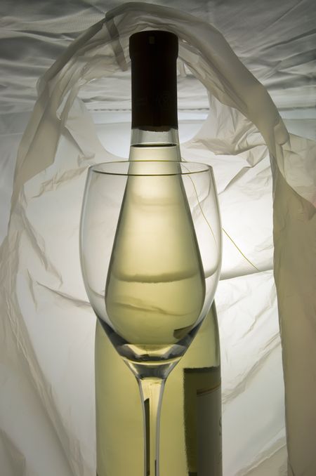 Wine glass and bottle of wine inside a handled bag