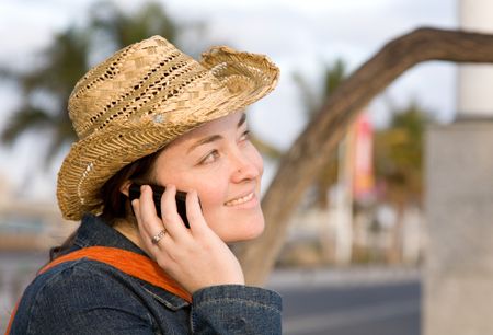 casual girl on the phone outdoors on a sunny summer day