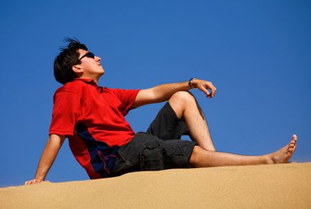 man relaxing at the beach on a sunny day