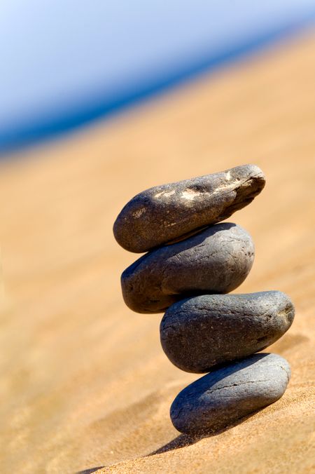 balancing stones on a sunny day at the beach