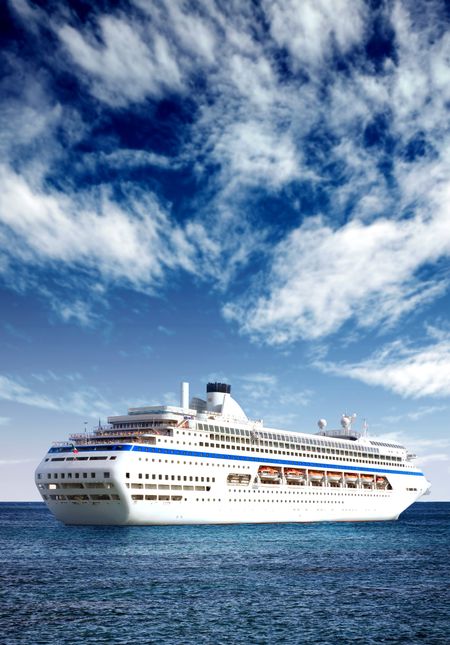 cruise liner in open sea with a beautiful blue sky behind it