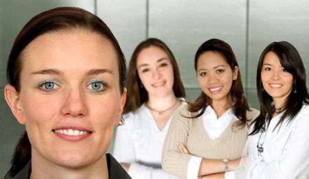 beautiful business woman and her team in an office - female only
